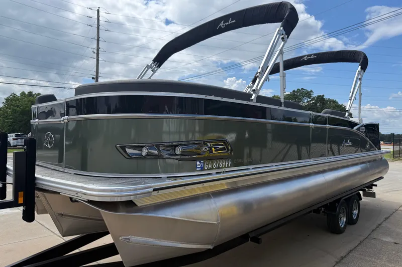 Slide: The Image of 2022 Avalon Catalina VRL 25' pontoon boat on trailer, under cloudy sky. - 4