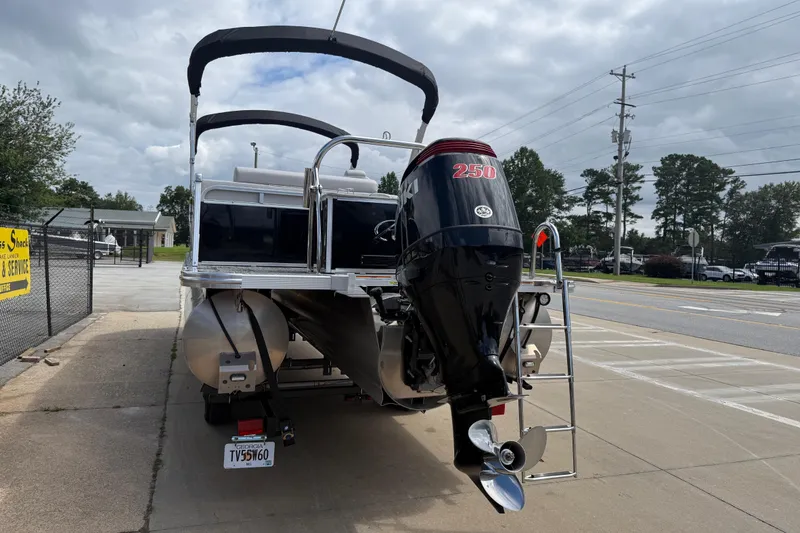 Slide: The Image of 2022 Avalon Catalina VRL 25' pontoon boat with powerful 250 HP engine, parked outdoors. - 5