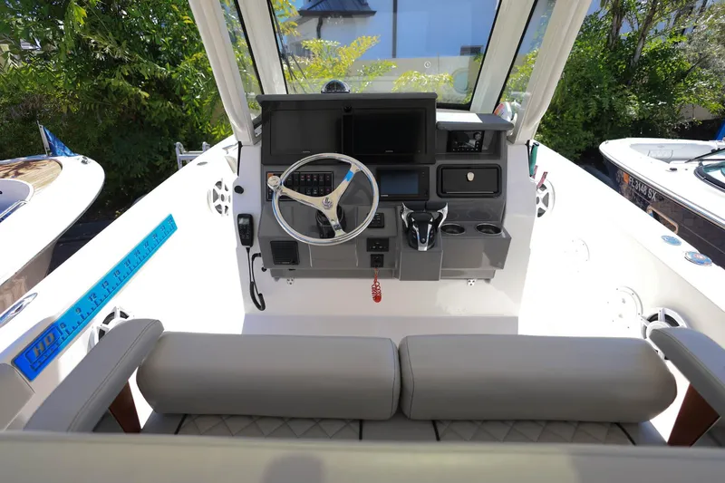 Slide: The Image of 2022 Pursuit S 288 Sport boat cockpit with steering wheel and control panel. - 15