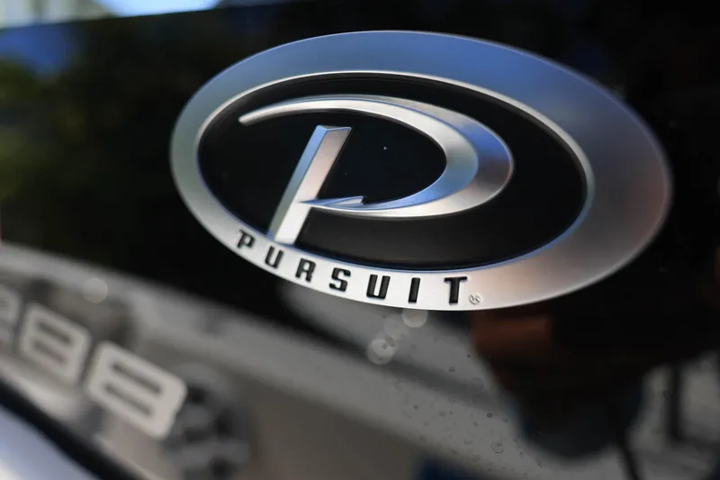 Slide: The Image of Close-up of 2022 Pursuit S 288 Sport logo on a sleek black surface. - 23