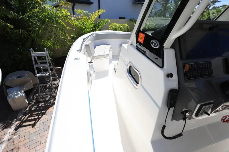 Slide: The Image of 2022 Pursuit S 288 Sport boat interior with control panel and seating. - 24