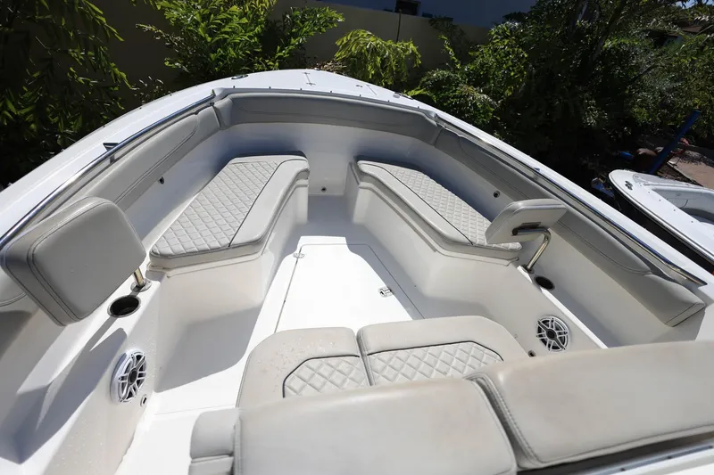 Slide: The Image of 2022 Pursuit S 288 Sport boat interior with cushioned seating and cup holders. - 26
