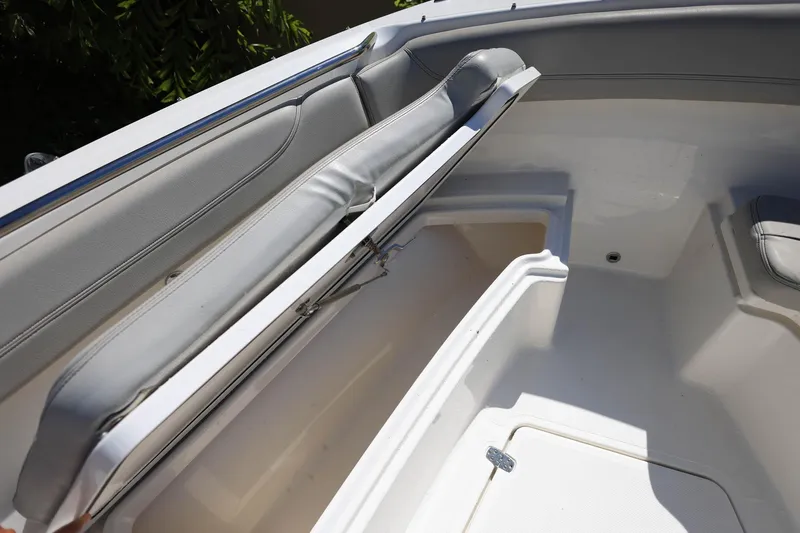 Slide: The Image of 2022 Pursuit S 288 Sport boat interior with open storage compartment and cushioned seating. - 27