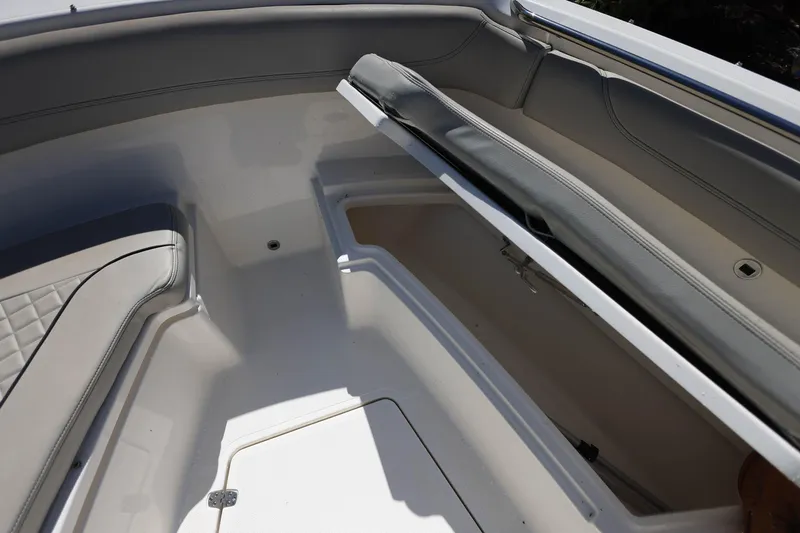 Slide: The Image of 2022 Pursuit S 288 Sport boat interior with open storage compartment. - 28