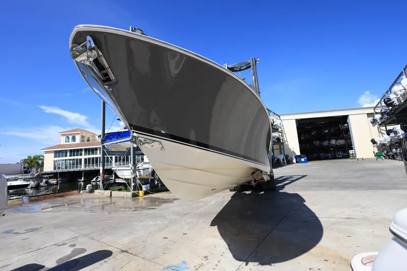 Slide: The Image of 2022 Pursuit S 288 Sport boat in a marina under clear blue sky. - 3