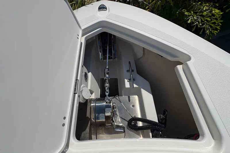 Slide: The Image of 2022 Pursuit S 288 Sport boat anchor compartment with chain and winch. - 30