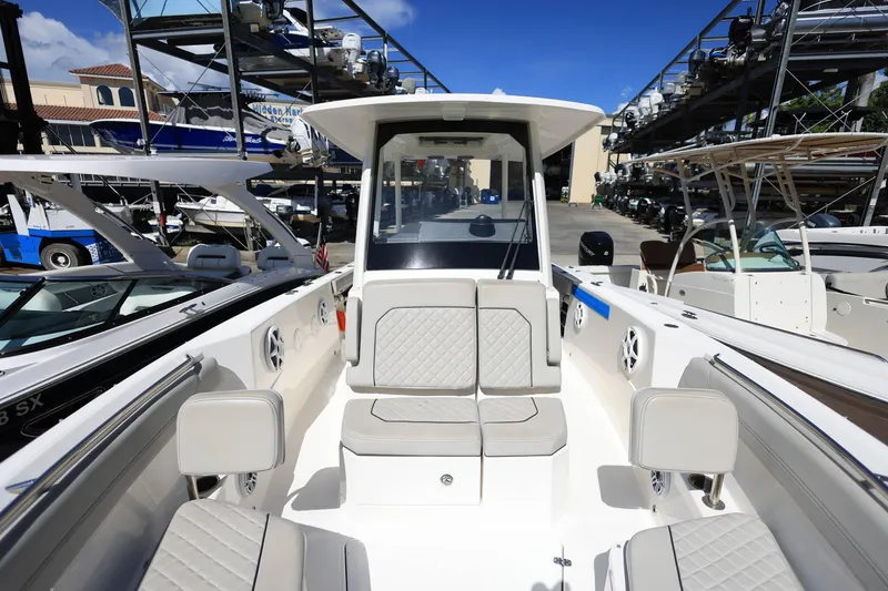 Slide: The Image of 2022 Pursuit S 288 Sport boat interior with cushioned seating and storage racks. - 31