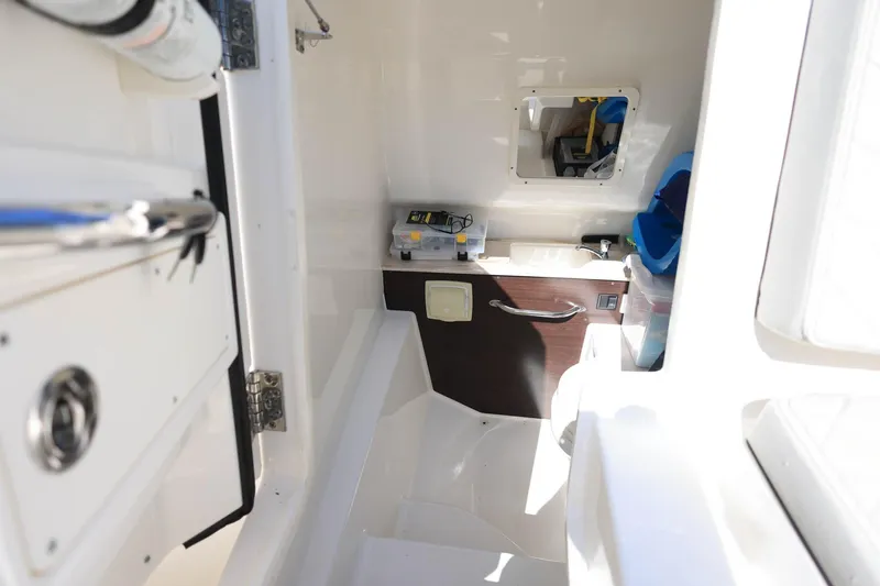 Slide: The Image of Interior of 2022 Pursuit S 288 Sport boat, featuring storage compartments and sleek design. - 32