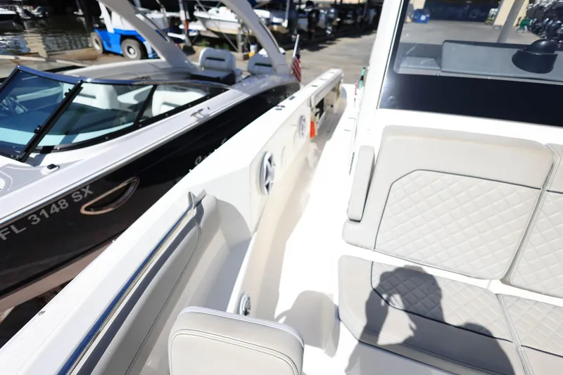 Slide: The Image of 2022 Pursuit S 288 Sport boat interior with cushioned seating and sleek design. - 36