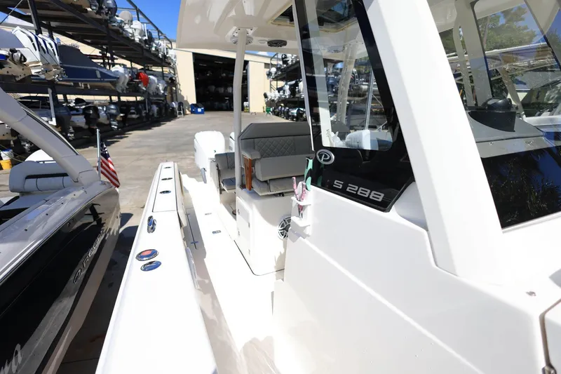 Slide: The Image of 2022 Pursuit S 288 Sport boat docked, showcasing sleek design and modern features. - 37
