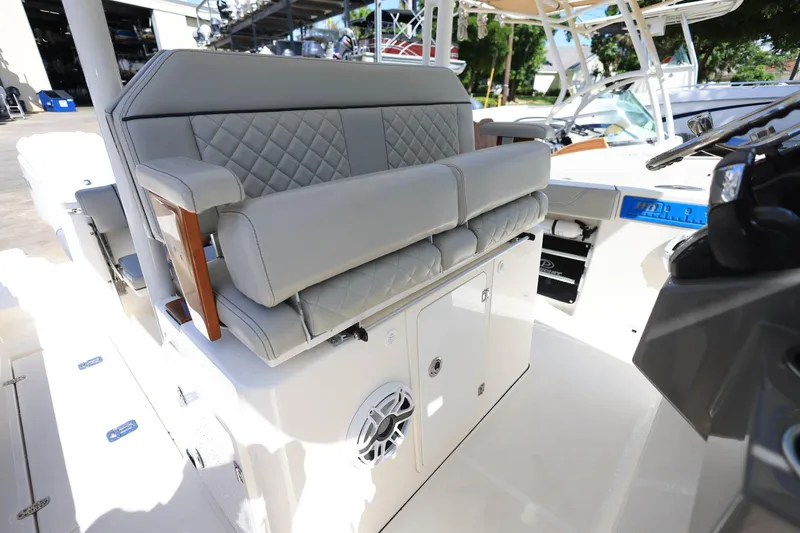 Slide: The Image of 2022 Pursuit S 288 Sport boat interior with cushioned seating and modern dashboard. - 38