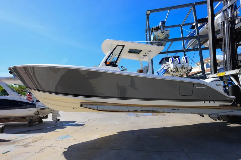 Slide: The Image of 2022 Pursuit S 288 Sport boat on lift, showcasing sleek design and modern features. - 4