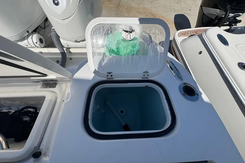 Slide: The Image of Open hatch on 2022 Pursuit S 288 Sport boat, revealing storage compartment. - 44