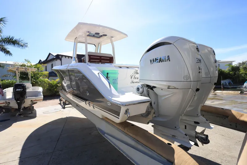 Slide: The Image of 2022 Pursuit S 288 Sport boat with Yamaha engines, docked outdoors. - 6