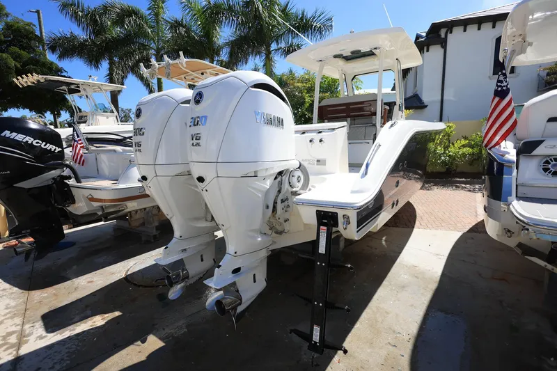 Slide: The Image of 2022 Pursuit S 288 Sport boat with dual Yamaha V6 engines, docked outdoors. - 8