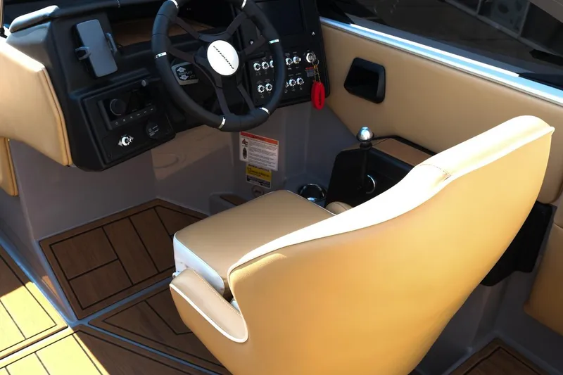 Slide: The Image of 2023 Moomba Mondo boat interior with tan seating and modern steering console. - 12