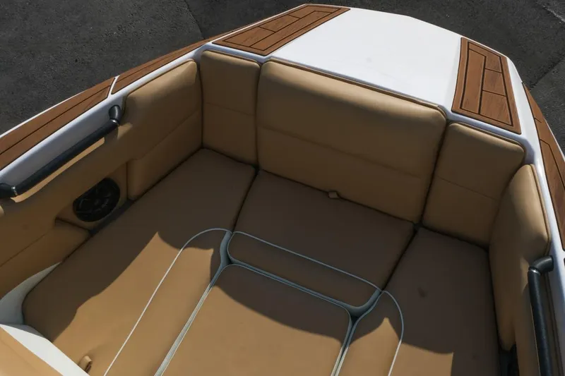 Slide: The Image of 2023 Moomba Mondo boat interior with tan seating and wood accents. - 20