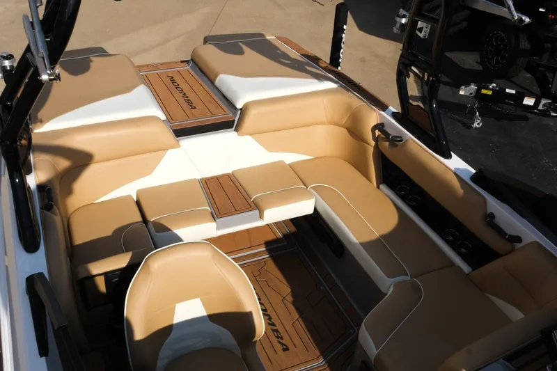 Slide: The Image of 2023 Moomba Mondo boat interior with tan and white seating, showcasing luxury design. - 21
