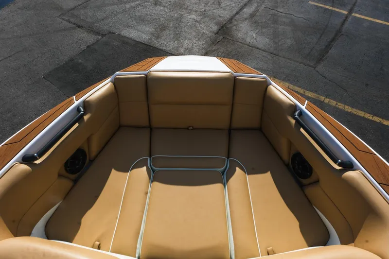 Slide: The Image of 2023 Moomba Mondo boat interior with tan seating and wood accents. - 22