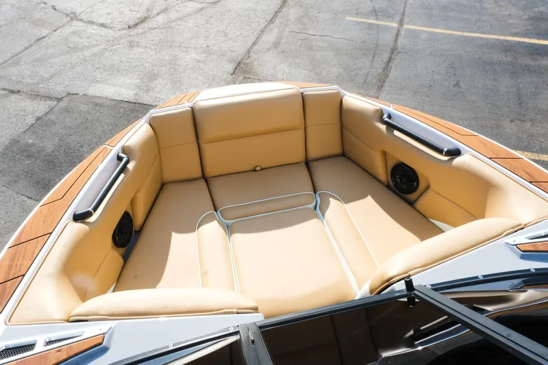 Slide: The Image of 2023 Moomba Mondo boat interior with tan seating and speakers. - 23