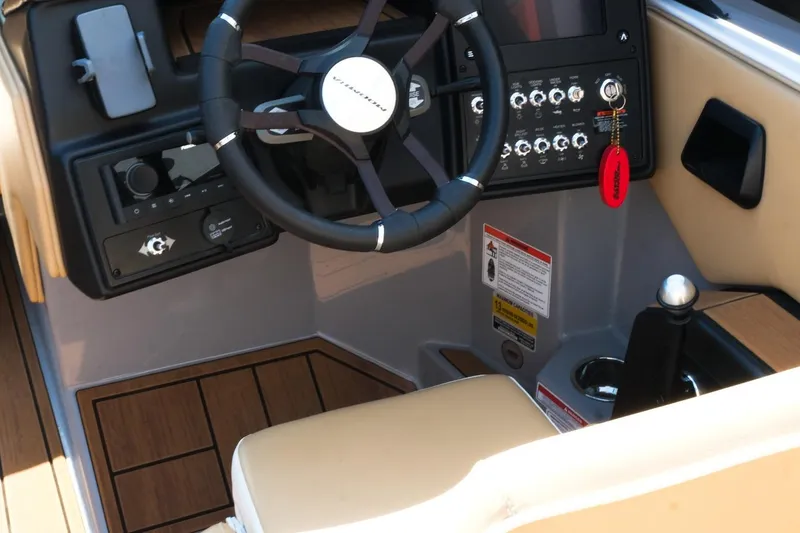 Slide: The Image of 2023 Moomba Mondo boat dashboard with steering wheel and control panel. - 24