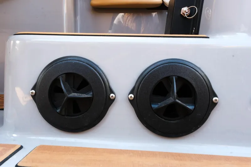 Slide: The Image of 2023 Moomba Mondo boat with dual black exhaust vents on a sleek white surface. - 25