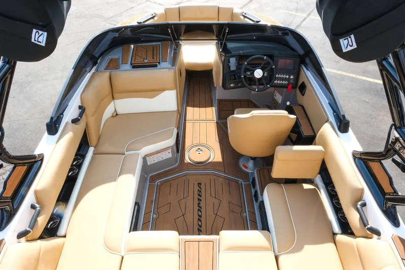 Slide: The Image of 2023 Moomba Mondo boat interior with tan seating and modern dashboard design. - 26