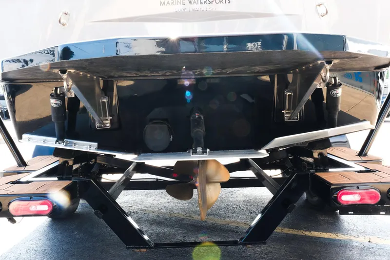 Slide: The Image of 2023 Moomba Mondo boat rear view showcasing propeller and trim tabs. - 28