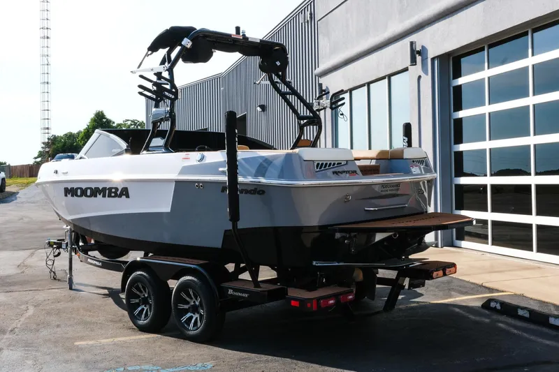 Slide: The Image of 2023 Moomba Mondo boat on trailer outside a modern building. - 3