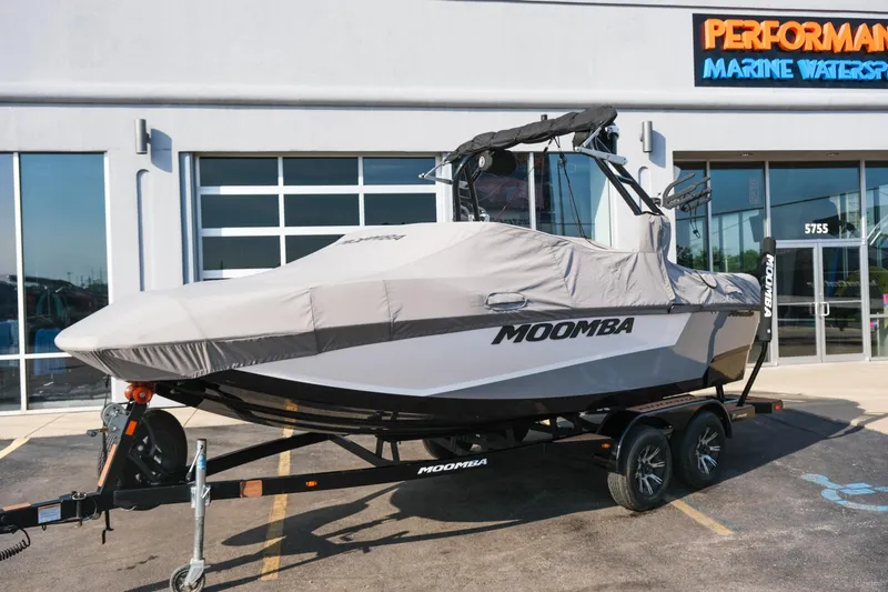 Slide: The Image of 2023 Moomba Mondo boat on trailer, covered, outside Performance Marine Watersports store. - 7
