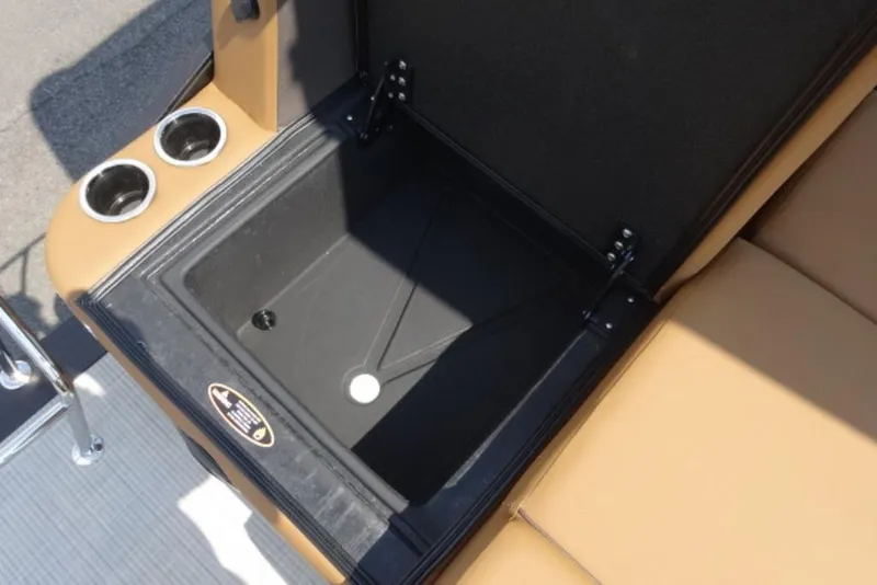 Slide: The Image of Open storage compartment on 2025 Harris Cruiser 250 LUX boat with cup holders. - 10