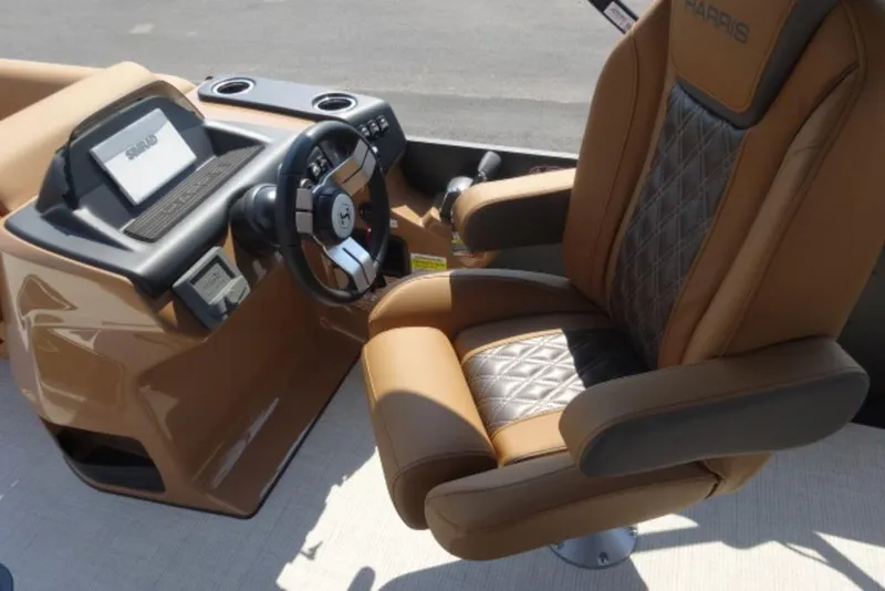 Slide: The Image of Luxurious helm of 2025 Harris Cruiser 250 LUX with plush captain's chair and modern controls. - 11