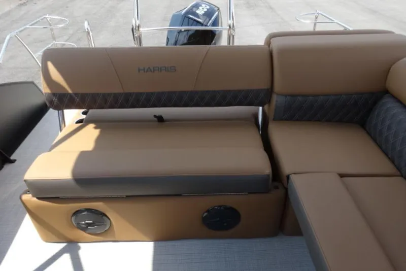 Slide: The Image of 2025 Harris Cruiser 250 LUX boat interior with tan and gray seating. - 12