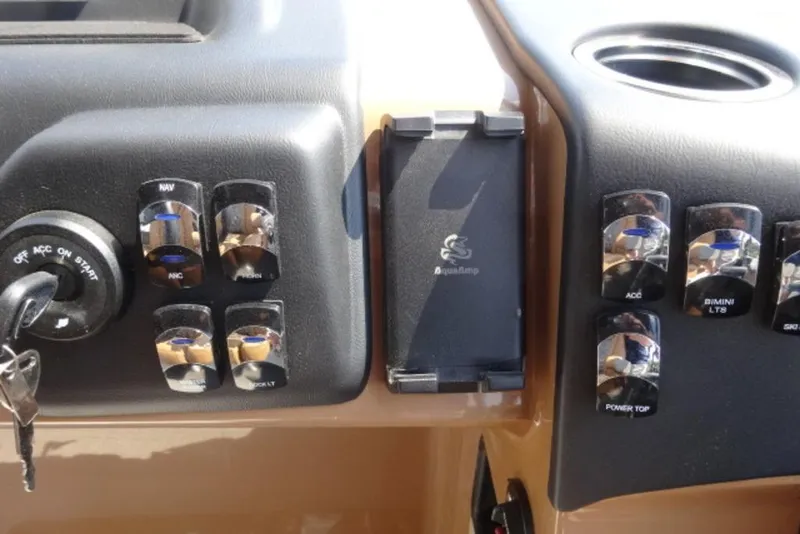 Slide: The Image of Dashboard controls of 2025 Harris Cruiser 250 LUX boat with ignition and switches. - 4