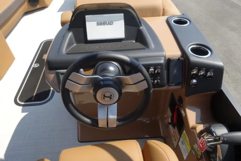 Slide: The Image of 2025 Harris Cruiser 250 LUX boat dashboard with steering wheel and Simrad display. - 5