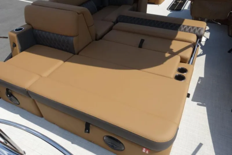 Slide: The Image of Luxurious seating on 2025 Harris Cruiser 250 LUX boat, featuring tan upholstery and cup holders. - 7