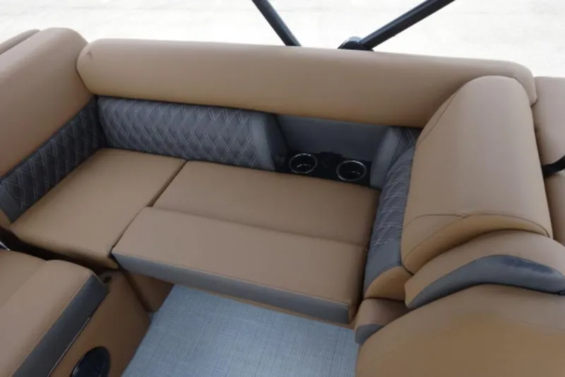 Slide: The Image of 2025 Harris Cruiser 250 LUX boat interior with tan and gray cushioned seating. - 9