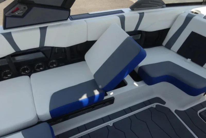 Slide: The Image of 2026 Malibu 23 MXZ boat interior with stylish blue and gray seating. - 11