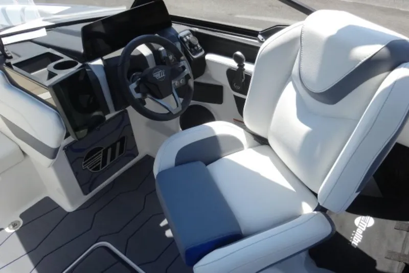 Slide: The Image of 2026 Malibu 23 MXZ boat interior with modern steering and comfortable seating. - 12