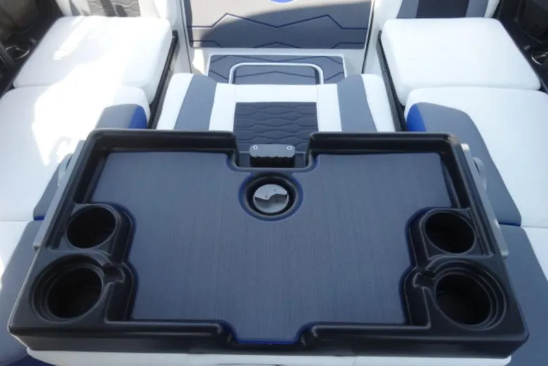 Slide: The Image of Interior of 2026 Malibu 23 MXZ boat with cup holders and seating area. - 13