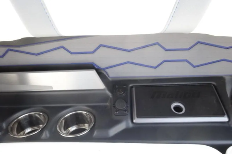 Slide: The Image of Interior detail of 2026 Malibu 23 MXZ boat with cup holders and sleek design. - 14