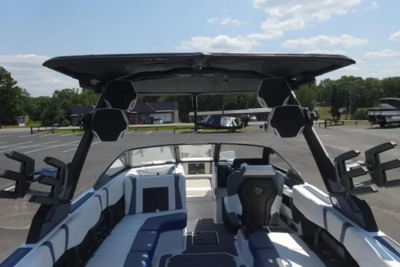 Slide: The Image of 2026 Malibu 23 MXZ boat interior with sleek seating and advanced audio system. - 2