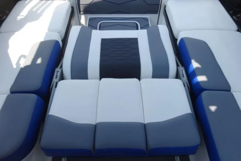 Slide: The Image of 2026 Malibu 23 MXZ boat interior with blue and gray cushioned seating. - 6