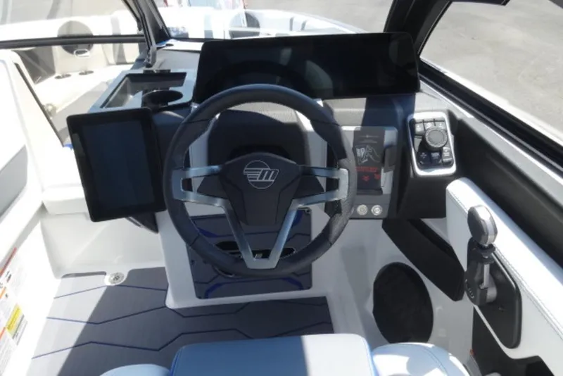 Slide: The Image of 2026 Malibu 23 MXZ boat cockpit with modern steering and digital controls. - 9