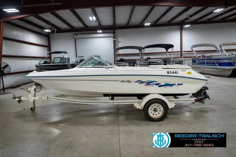 Slide: The Image of 1995 Sea Ray 175 Bow Rider boat on trailer in indoor storage facility. - 10