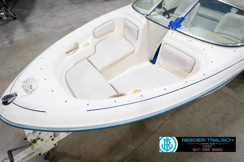 Slide: The Image of 1995 Sea Ray 175 Bow Rider boat on trailer in indoor showroom. - 11