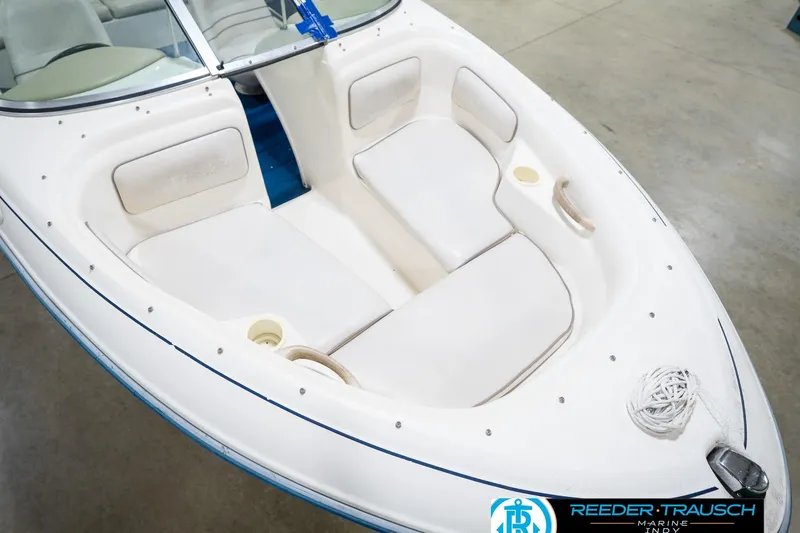 Slide: The Image of 1995 Sea Ray 175 Bow Rider boat interior with white seating and windshield. - 12