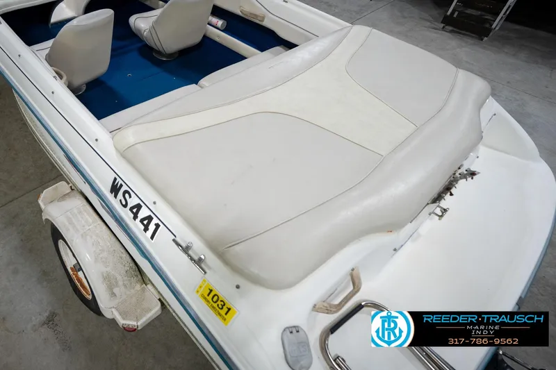 Slide: The Image of 1995 Sea Ray 175 Bow Rider boat interior with white seating and blue carpet. - 14