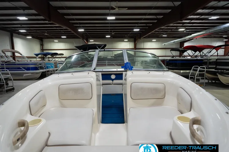 Slide: The Image of 1995 Sea Ray 175 Bow Rider interior with white seating and blue carpet. - 15