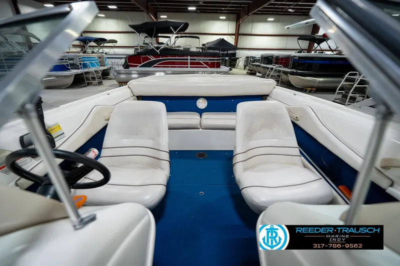 Slide: The Image of Interior view of a 1995 Sea Ray 175 Bow Rider boat, featuring steering wheel and dashboard. - 17